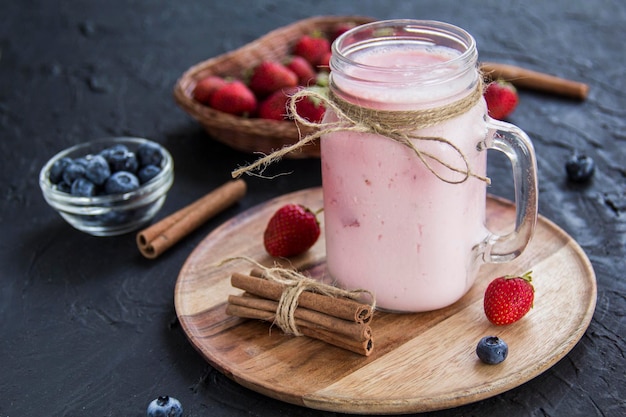 Healthy smoothie of fresh summer berries. Creative atmospheric decoration