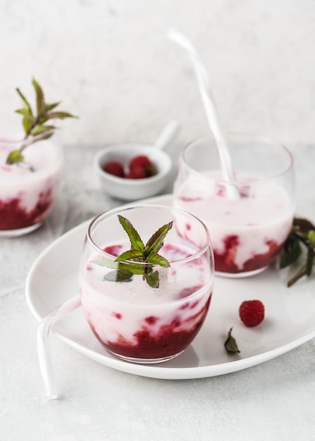 Healthy summer berry drink of raspberry sauce and buttermilk smoothie