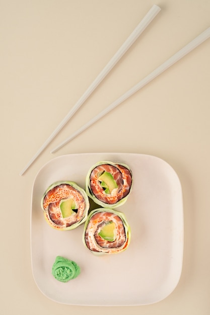 Healthy sushi roll with cucumber, salmon and avocado