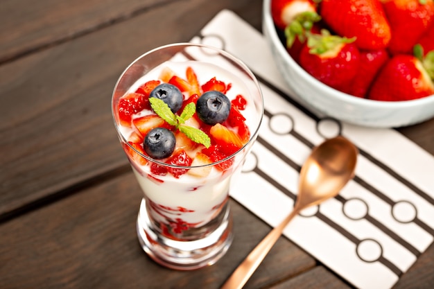 Healthy sweet dessert in glass with strawberries