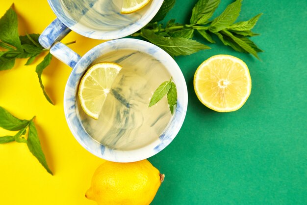 Healthy tea cups with lemon, ginger and mint