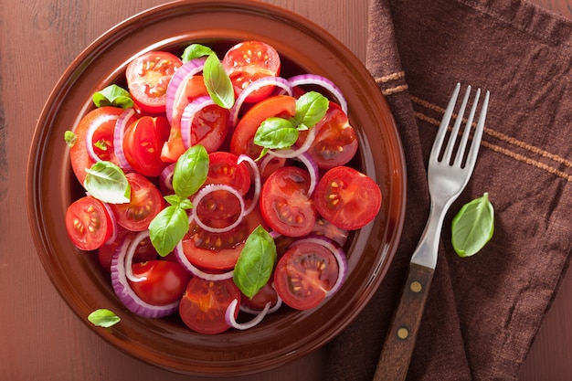 Healthy tomato salad with onion basil olive oil and balsamic vinegar