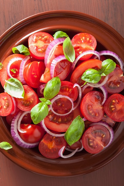 Healthy tomato salad with onion basil olive oil and balsamic vinegar