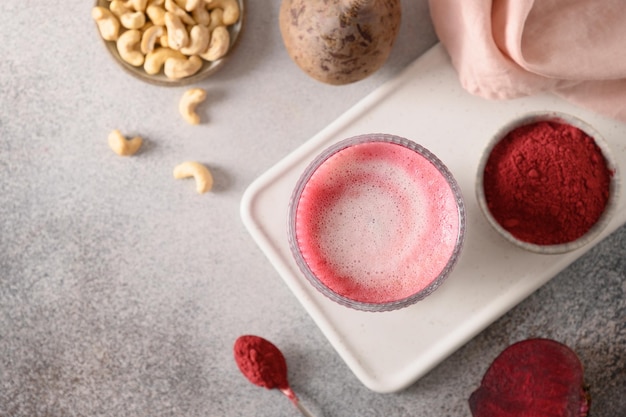 Healthy vegan beetroot latte with cashew nuts milk View from above