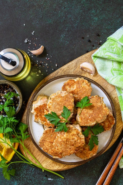 Healthy vegan food Red fish cutlets on a dark stone or slate table Top view Copy space