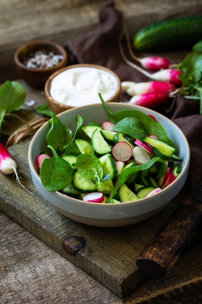 Healthy vegan food Vegetarian vegetable salad of spinach radish and fresh cucumber Copy space