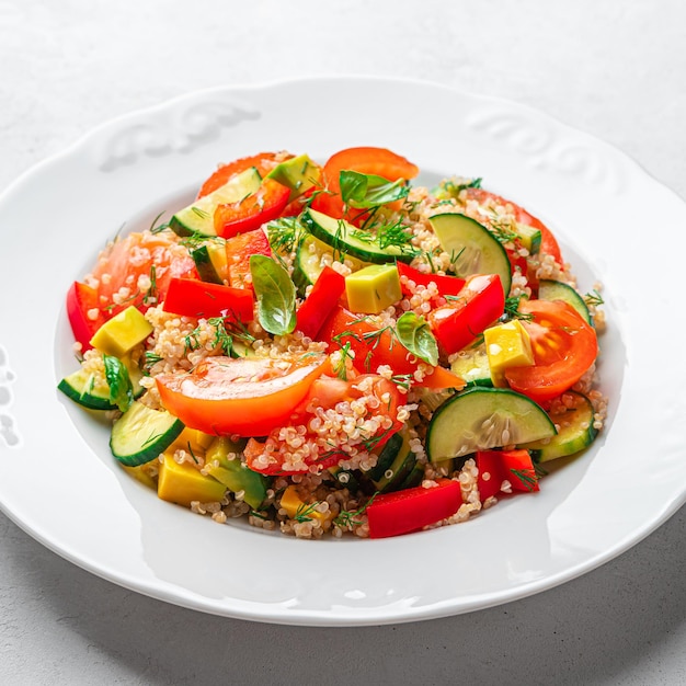 Healthy vegetable salad with quinoa and fresh herbs on a gray background Tabbouleh salad Side view closeup