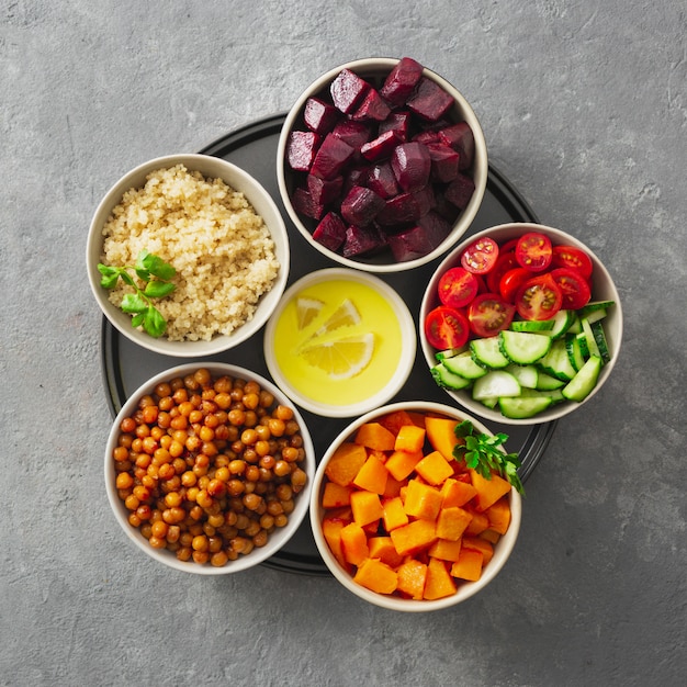 Healthy vegetarian ingredients for cooking moroccan salad. Chickpeas, Baked pumpkin and beets, quinoa and vegetables top view