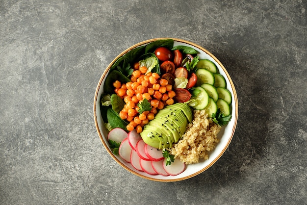 Healthy vegetarian salad with chickpeas, quinoa, cucumber, radish, and avocado