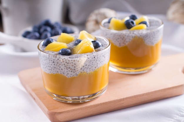 Healthy vegetarian vanilla Chia pudding in a glass with fresh berries on coconut milk