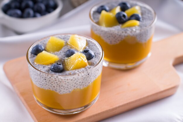 Healthy vegetarian vanilla Chia pudding in a glass with fresh berries on coconut milk