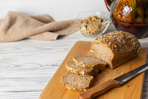 Healthy whole grain bread on wooden board in the kitchen