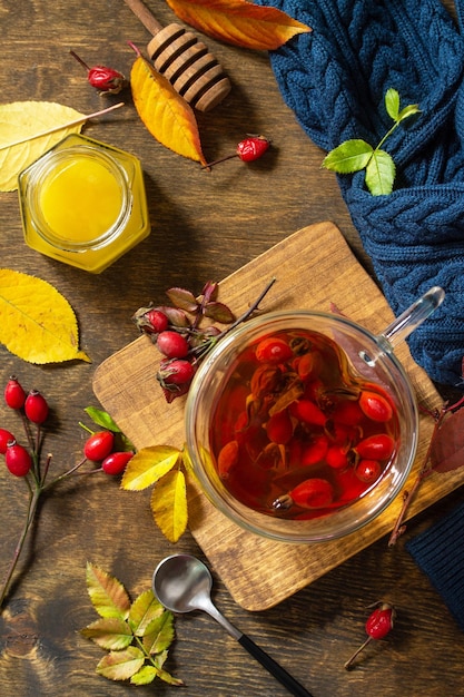 Healthy winter vitamin drink Hot rosehip tea with honey and dried fruits Top view