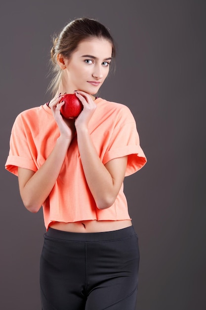 Healthy woman holding an apple and dieting