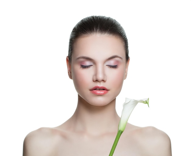 Healthy woman with clear skin and lily flower isolated on white Spa beauty portrait