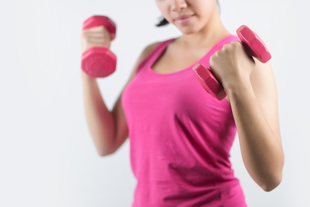 Healthy  woman with dumbbells working out isolated on white background