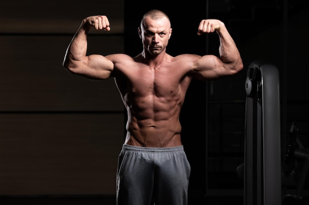 Healthy Young Man Flexing Muscles