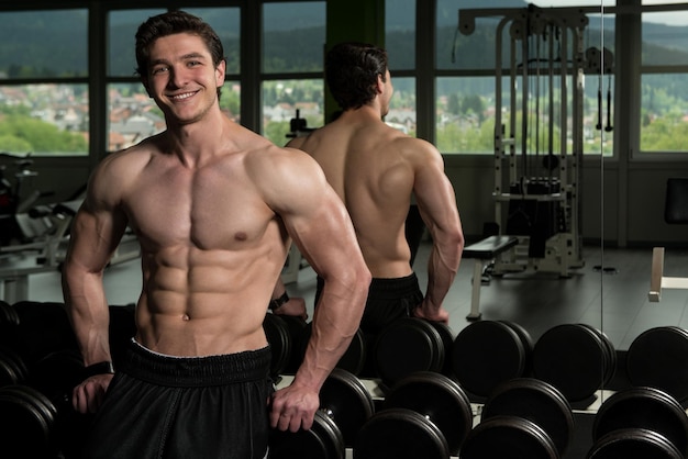 Healthy Young Man Flexing Muscles