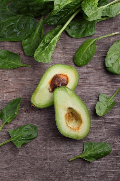 Healty green vegetable: spinach, cucumber, lettuce, apple and avocado on dark background. flat lay, copy space.