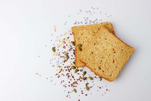 Healty tasty multigrain bread with pumpkin chia flax seeds on white background