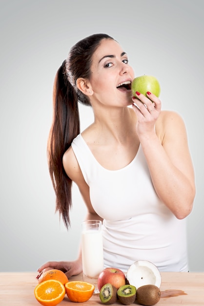 Healty young woman eating an apple. Healthy food concept.