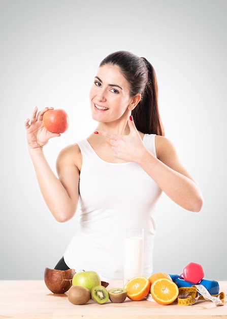 Healty young woman eating an apple. Healthy food concept.