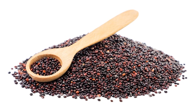 Heap of black quinoa with a spoon on a white background Isolated