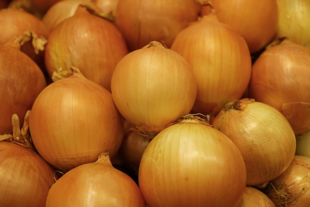 Heap of bulb onions selling on the market