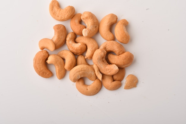 Heap of cashew nuts on white