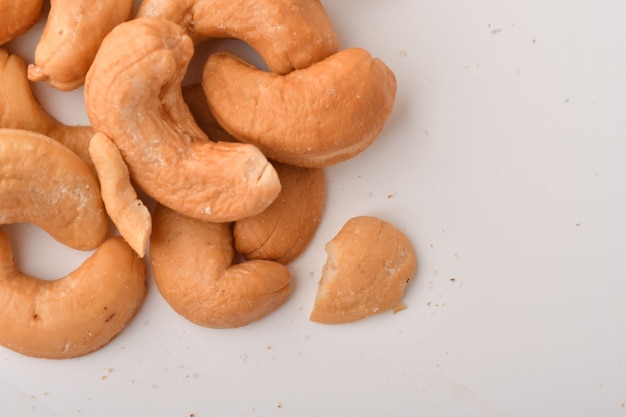 Heap of cashew nuts on white