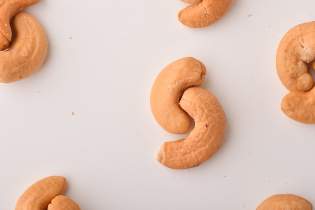 Heap of cashew nuts on white