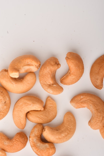 Heap of cashew nuts on white