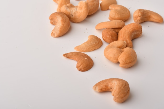 Heap of cashew nuts on white