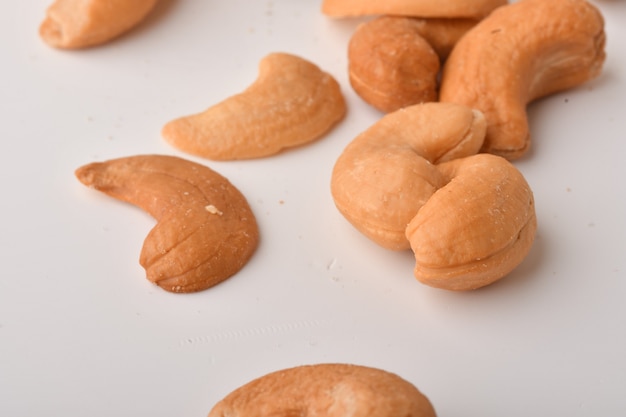 Heap of cashew nuts on white