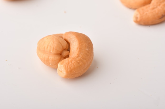 Heap of cashew nuts on white