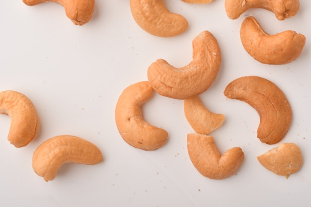 Heap of cashew nuts on white