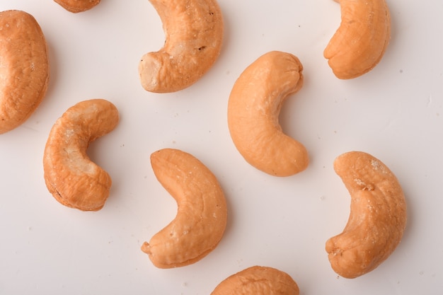 Heap of cashew nuts on white