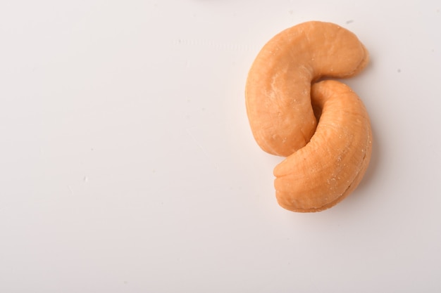 Heap of cashew nuts on white