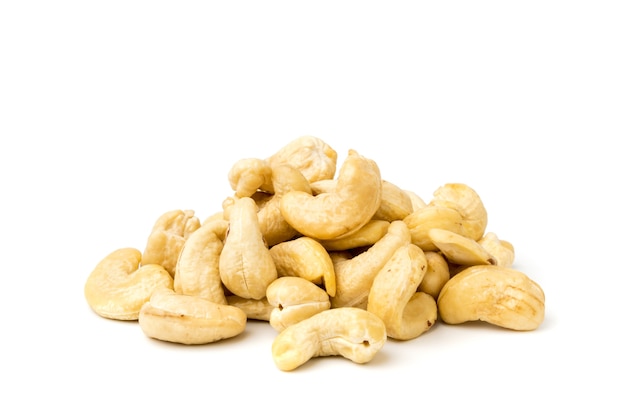 Heap of cashews on a white surface, isolated