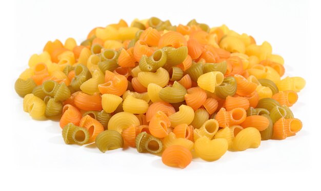 Heap of colored uncooked italian pasta pipe rigate on a white background