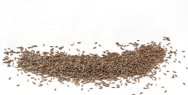 Heap of cumin seeds isolated on white background