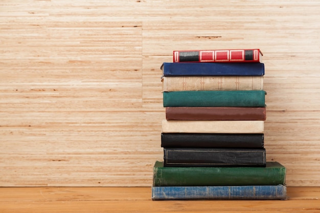 Heap of different books on wooden background