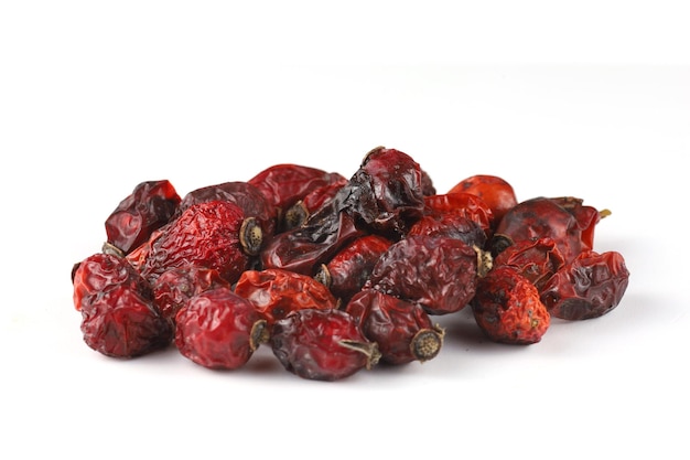 Heap of dried rose hips on a white background isolate