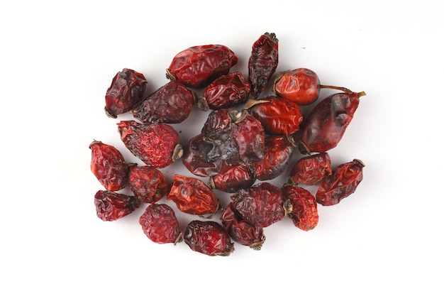 Heap of dried rose hips on a white background isolate