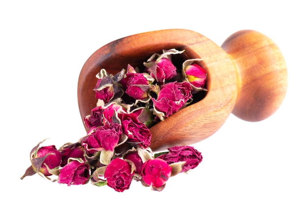 Heap of dry tea roses buds in wooden scoop isolated on white background Rose flower tea Phnom Penh rose tea Clipping path