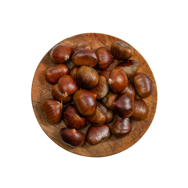 Heap of edible sweet whole chestnuts isolated on white background top view.