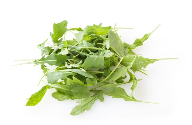 Heap of fresh arugula leaves isolated on white background