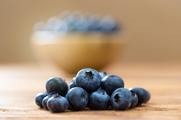 Heap of fresh blueberries lying on wooden table