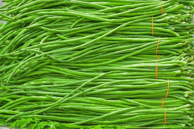 Heap of fresh yardlong beans (Asparagus bean) on shelf at a fresh market