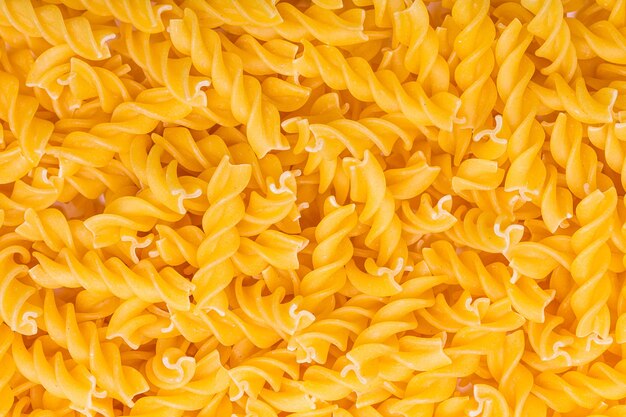 A heap of fusilli noodles pasta background. Taken in Studio with a 5D mark III.